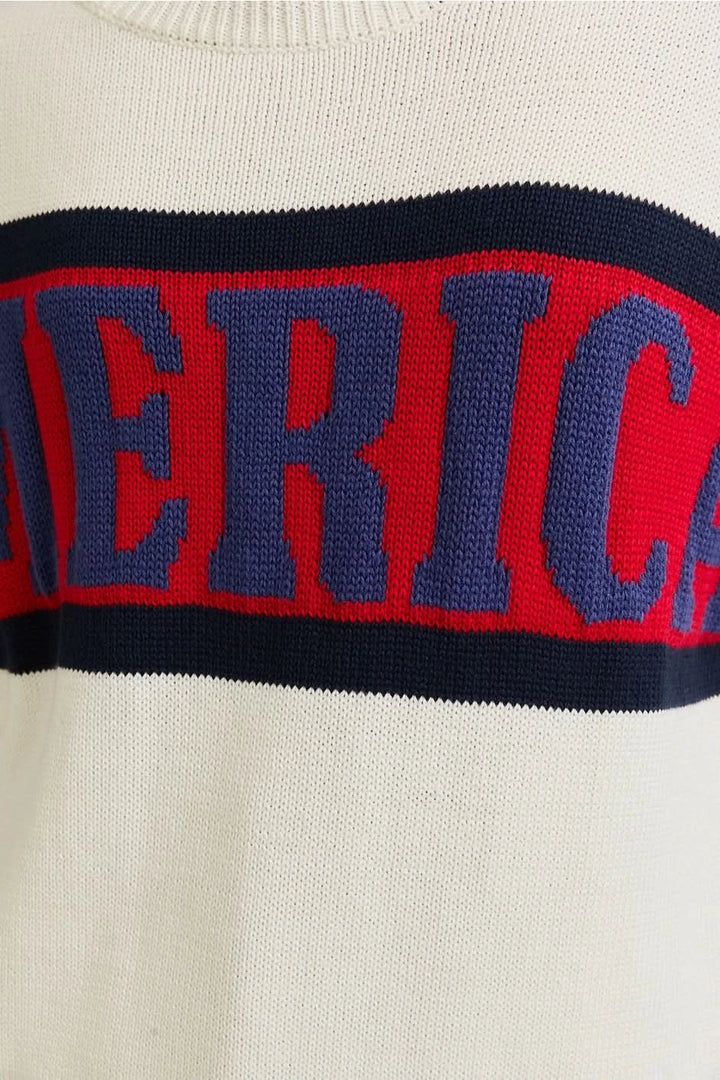 Woman wearing a patriotic AMERICA knit sweater in Red, White , and Blue . Perfect for Memorial Day